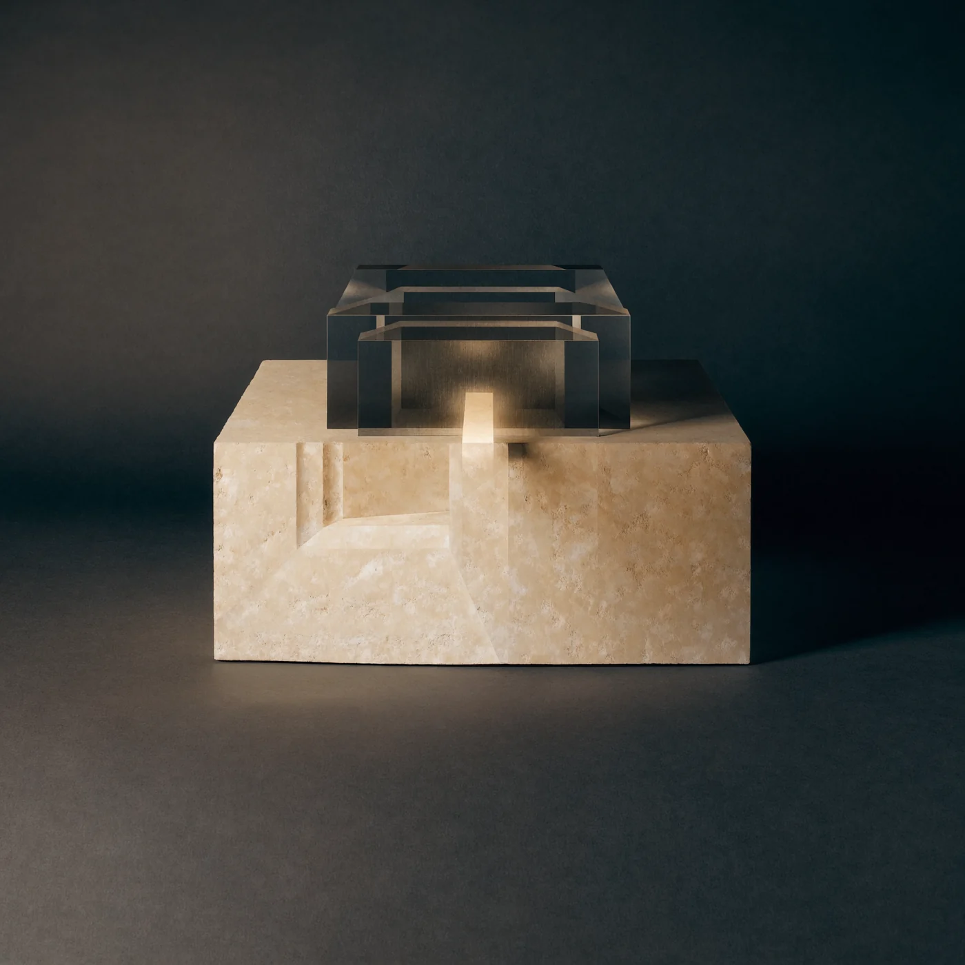 Warm light passes through layered glass onto a carved stone plinth.